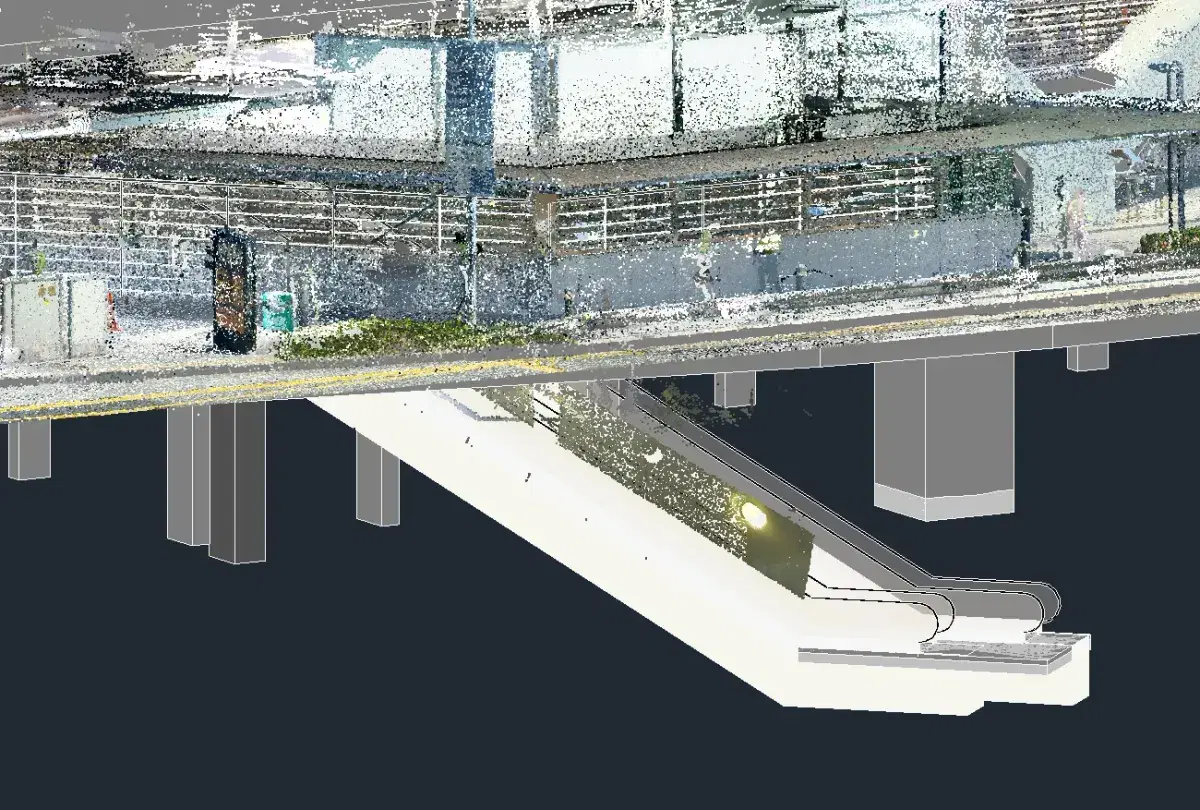 Point cloud data overlaid on a BIM model showing an escalator and structural columns, used for as-built verification
